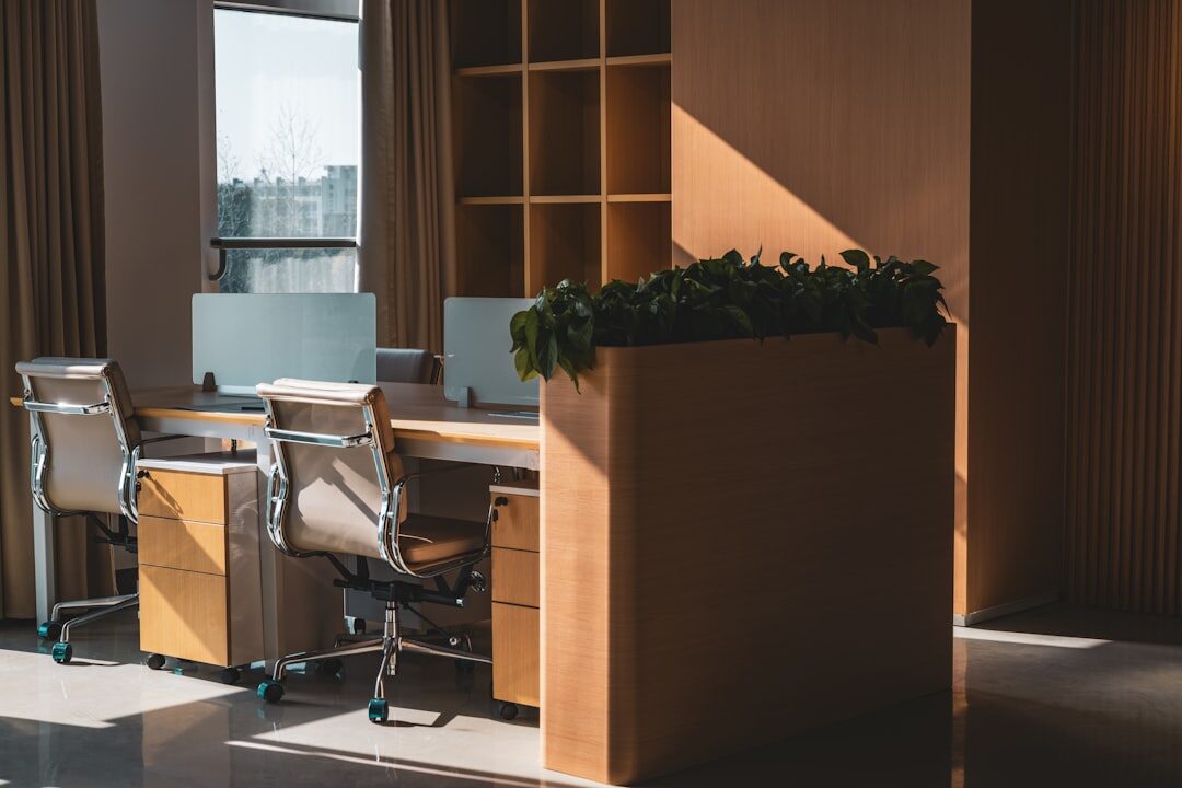Modern newsroom desk with monitors and notebooks
