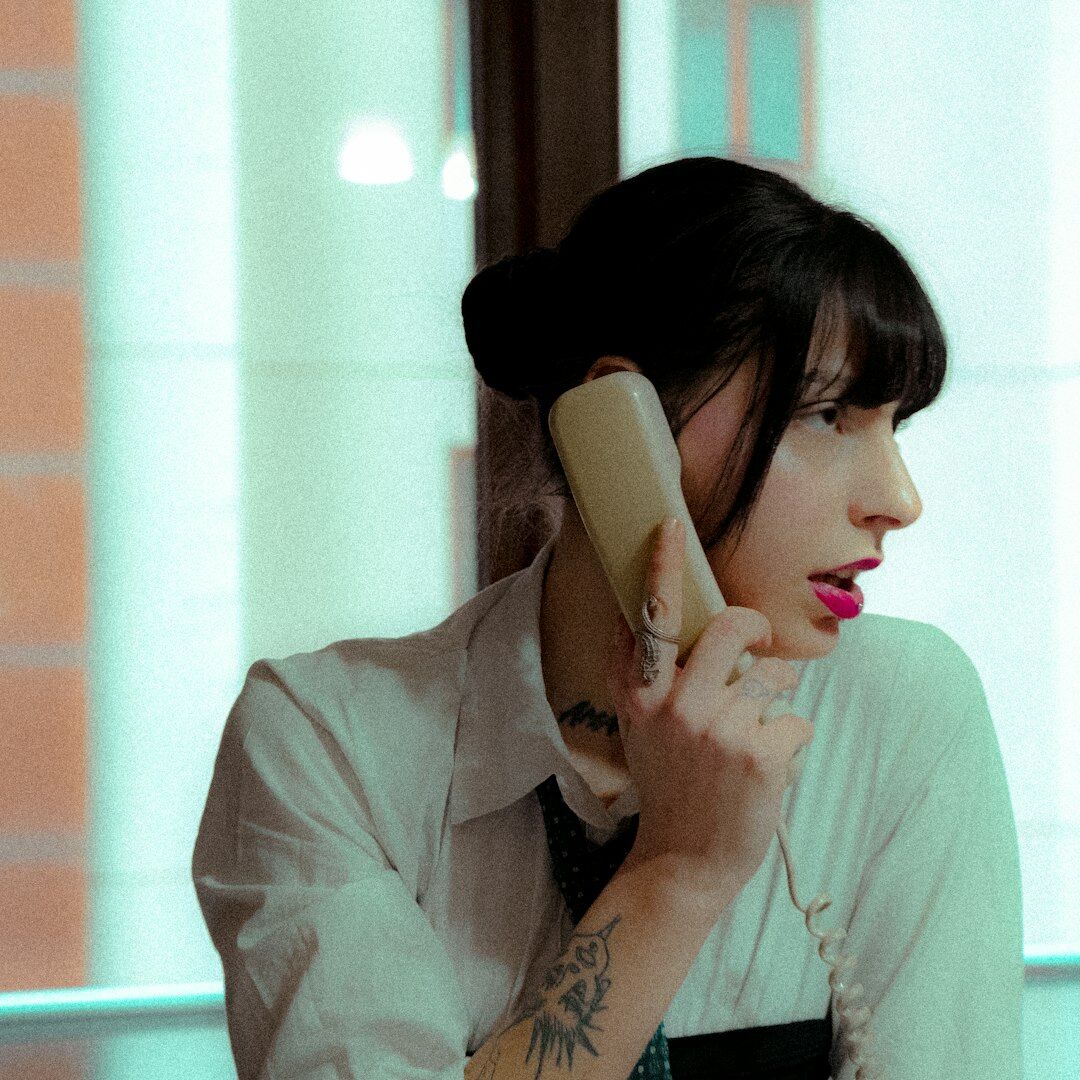 Portrait of a smiling Uruguayan woman reading on a phone